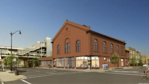 A rendering of a brick concert hall with retail space next to an elevated train station.
